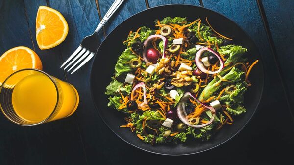 Fresh salad with grains and vegetables on a neutral plate